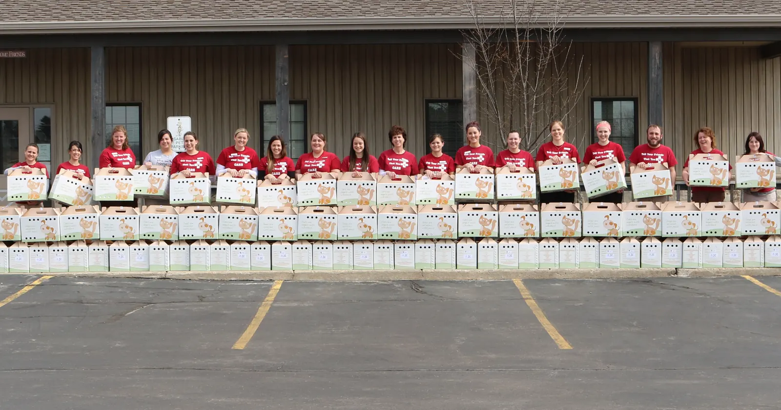 The Countrycare team in C.A.R.E. for Paws shirts in front of the clinic with pet disaster kits
